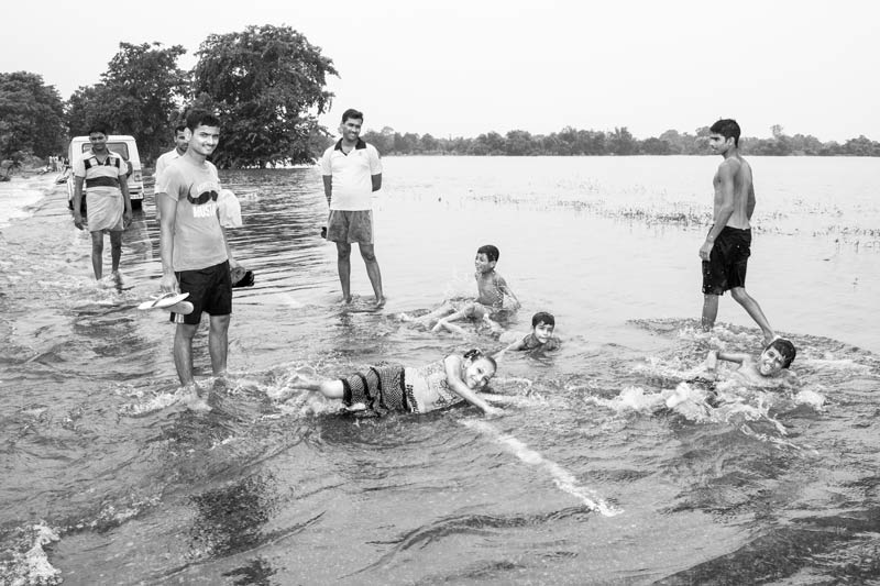 Water for Recreation and Enjoyment - in flood waters on National Highway 84, Bhojpur district, Bihar